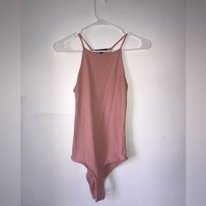 This light pink body suit is from the brand ambiance,  the size: M / Medium